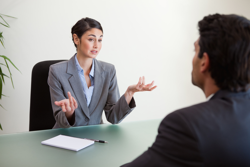 Manager interviewing an employee in her office